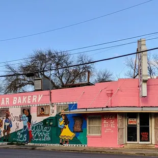 a pink building on a street corner