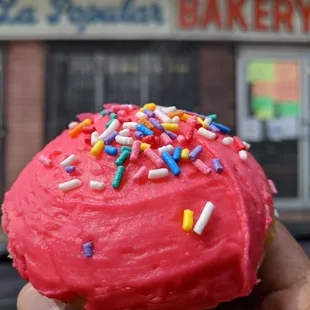 a pink frosted doughnut with sprinkles