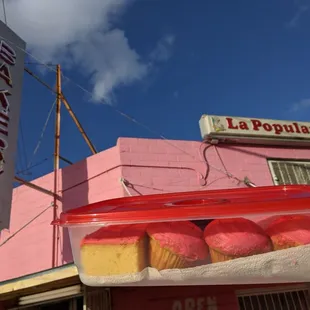 a person holding a container of donuts