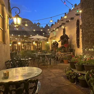 a patio with tables and chairs