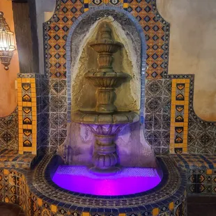 a fountain with a purple light