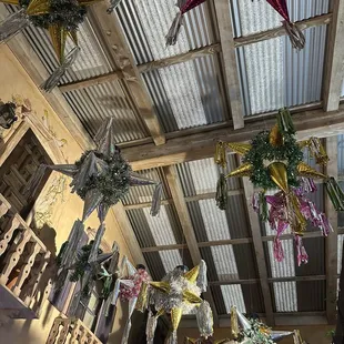 Shiny piñatas adorn the lobby ceiling