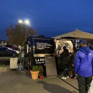 people standing in front of a food truck