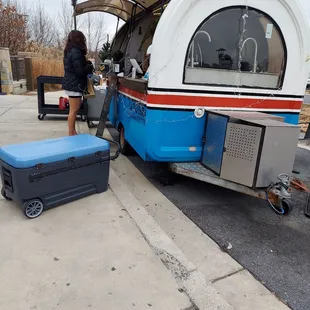 a woman loading a camper trailer