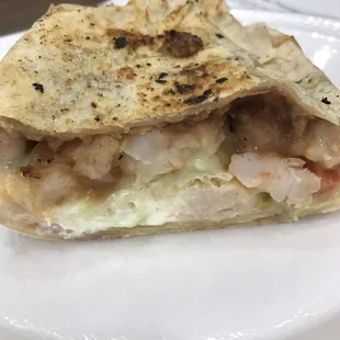 $7 Shrimp burrito. Lettuce, tomato, sour cream, cheese, guac, and beans. Did not have rice, onions, and cilantro.