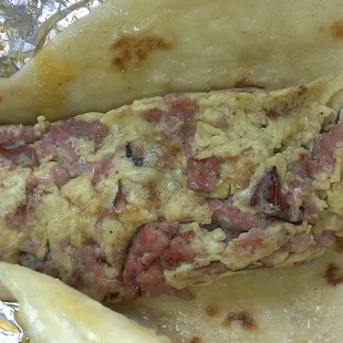 They call this country egg. It has smoked sausage and eggs griddled with chorizo juice.