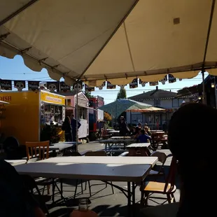 This cart is part of a food park. They have a pool table with missing balls and no ques as well as board games.