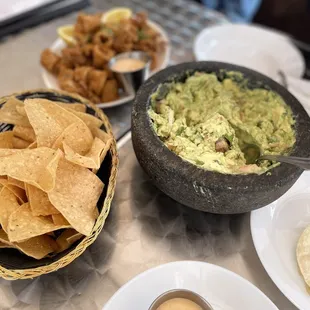 Guacamole and chips I also had a beef empanada that you can't really see and my friends enjoyed the fried calamari.