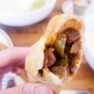 a hand holding a sandwich