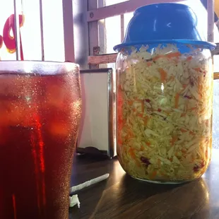 a glass of soda and a jar of sauerkraut