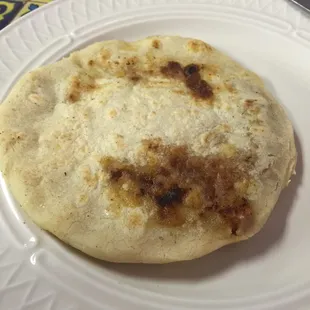 Pupusa, cheese, beef, &amp; beans in center.