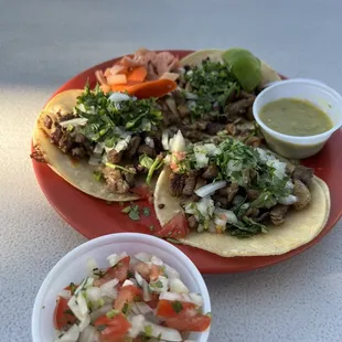 a plate of tacos and a bowl of salsa