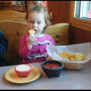 Enjoying the chips with salsa and cheese dip before the yummness comes out :)