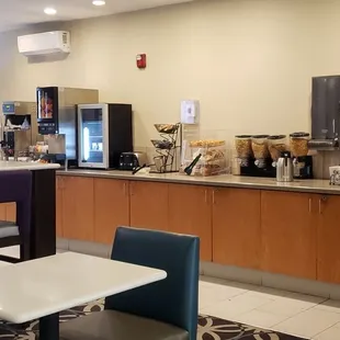 Continental breakfast counter where cereal + bagels + more are located