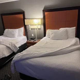 Where's the decorative throws the hotel advertises? No spare outlet to plug or charge anything at nightstand...