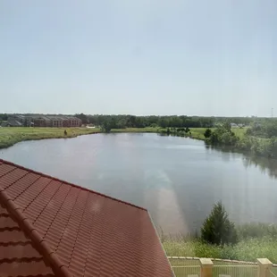 Pond/lake and lounge chairs on downstairs patio outside--as seen from our third floor room