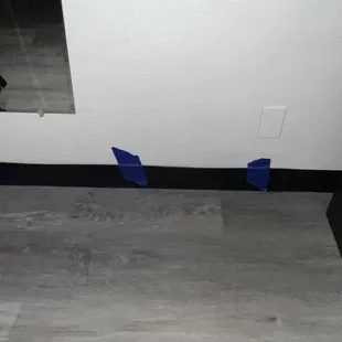 The trim that is being held up by painters tape