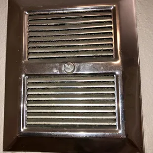 This is a wall heater in the bathroom, right above the commode. The dust is an inch thick.