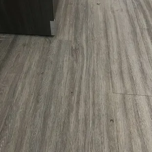 Dirty floors. They looked like no one swept or mopped