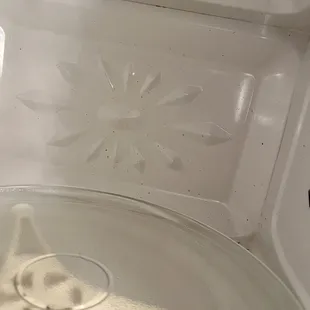 Microwave covered in specks of food