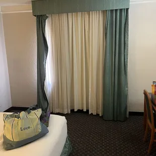 Torn and dirty curtains in the room.