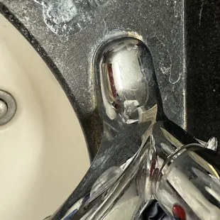 Dirty bathroom, sink, water fixtures.