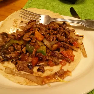 Beef taco $4.50. Marinated chunks of beef in a large thick flour tortilla