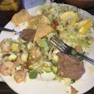 Separated shrimp, avocado, and cucumbers from all the extra extra lettuce