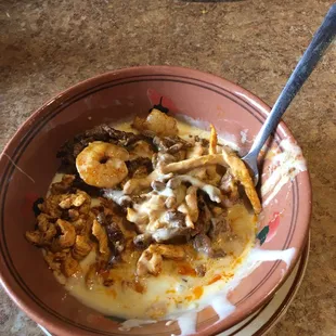 a bowl of food and a plate of salad