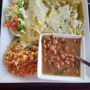 Cheese enchiladas with verde sauce, charro beams and rice.