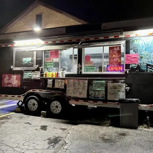 a food truck parked in front of a restaurant