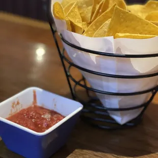 a bowl of chips and a bowl of ketchup