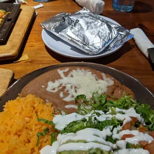 Rice, refried beans, tortilla, guacamole, veggies, tortilla