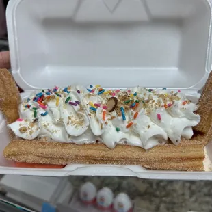 a banana split with whipped cream and sprinkles