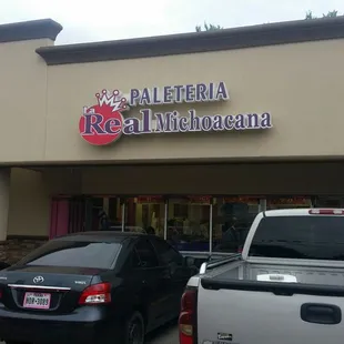 cars parked in front of a restaurant