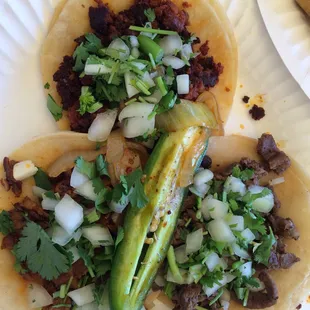 (Clockwise from top) Pastor, Asada, and Chorizo tacos.