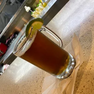a glass of beer on a counter