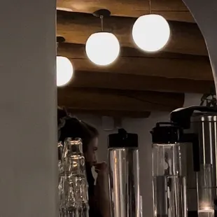 Bartender with no mask and eating behind the bar while on shift and was rude. Touching her nose. Not washing hands afterwards.