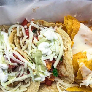 Veggie and chipotle chicken tacos with chips and queso