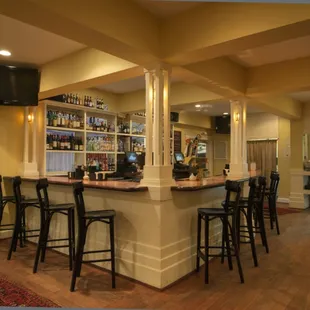 A warm and inviting bar with TVs.