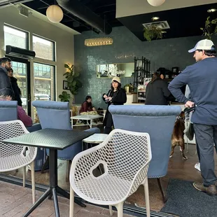 a group of people sitting at tables in a coffee shop