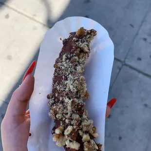 a hand holding a piece of food