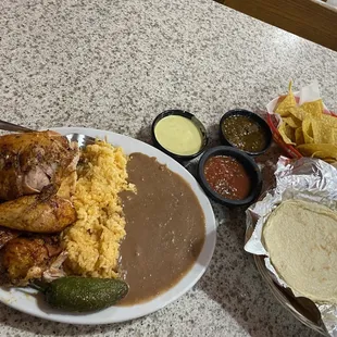 1/2 chicken with rice and beans. All salsas are great. The light green is nice and spicy.  Homemade tortillas like it&apos;s supposed to be.