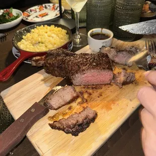 Tomahawk ribeye, truffle Mac n cheese, and sautéed spinach.