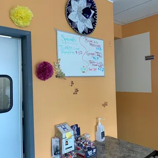 a kitchen with orange walls and a black and white checkered floor