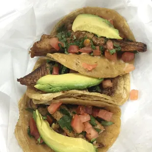 Blackened fish tacos topped with cilantro, tomatoes, &amp; avocado slices. Sprinkled lime juice &amp; hot salsa over them then Nom Nom Nom
