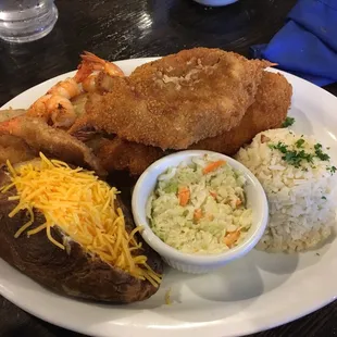 Marisco plate - stuffed crab, fish fillets, shrimp,  chopped crab, baked potato, rice &amp; slaw. Definitely a shareable plate.