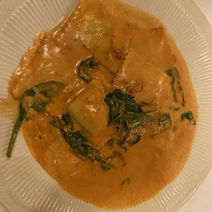 Butternut Squash Ravioli - Pasta pouches filled with butternut squash, topped with blended pink sauce and fresh spinach