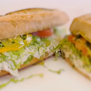A delicious &quot;Toone&quot; served on a house-baked baguette, filled with albacore salad, crisp lettuce, tomato, dill, and a pepperoncini mayo.