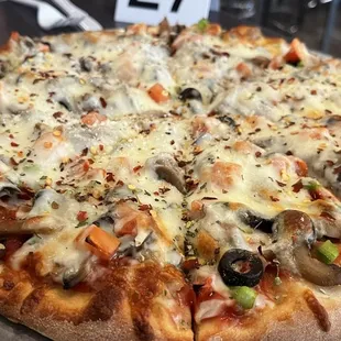 Medium veggie pizza with added crushed red peppers and Parmesan.